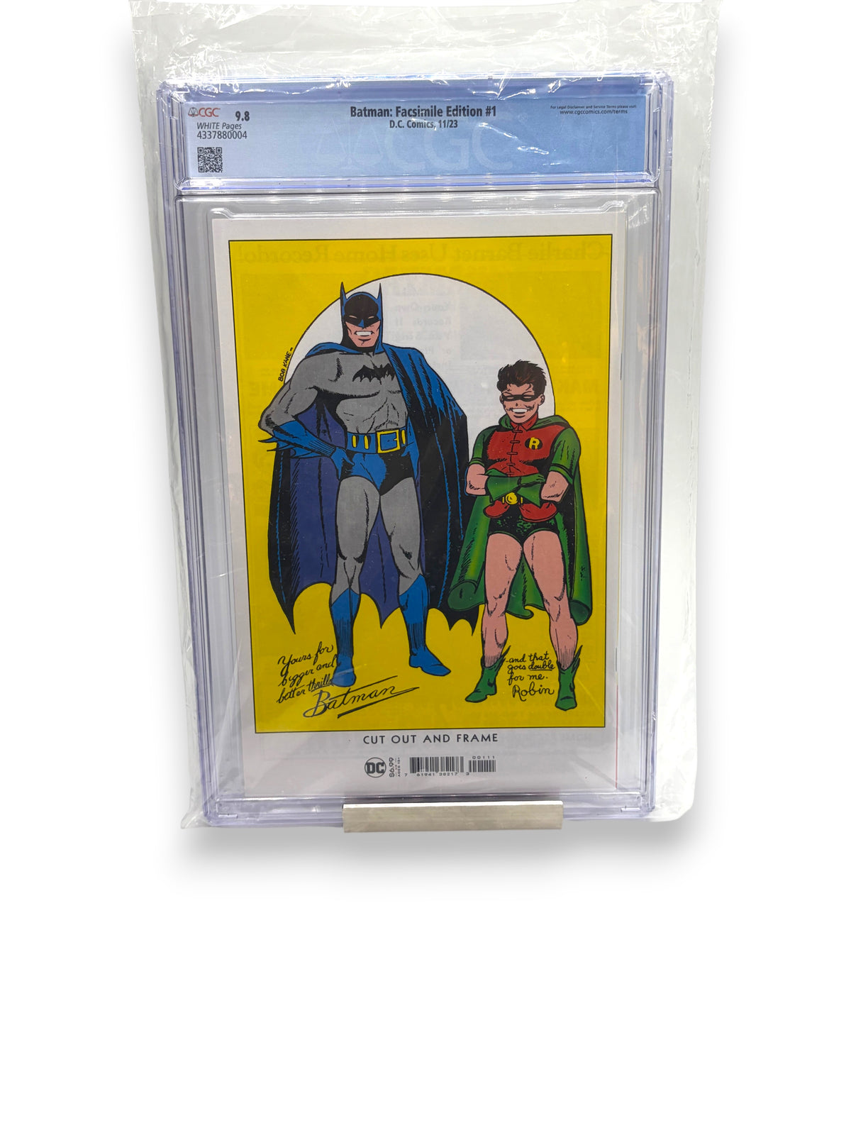 Lowkey Stock Batman #1 Facsimile Edition comic book in a CGC 9.8 graded protective slab with white pages.