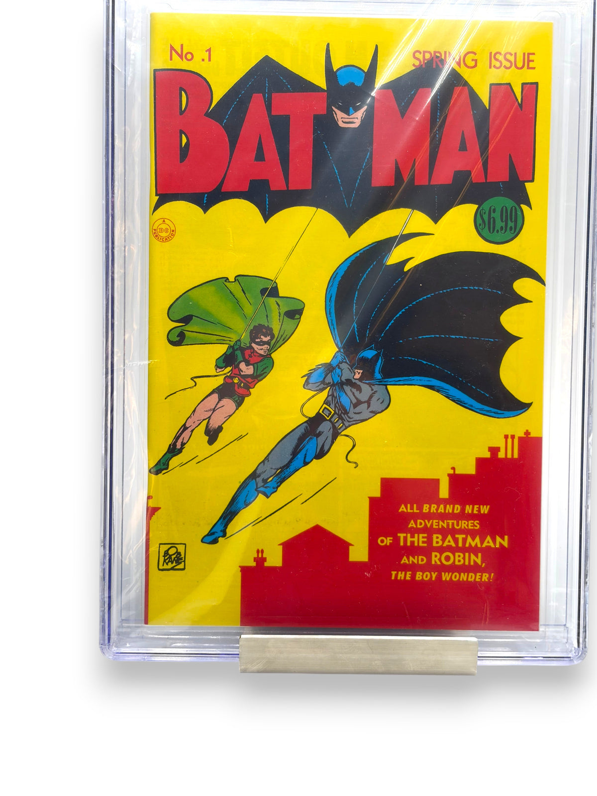 Lowkey Stock Batman #1 facsimile reprint comic book in a protective CGC 9.8 graded slab featuring Batman and Robin.