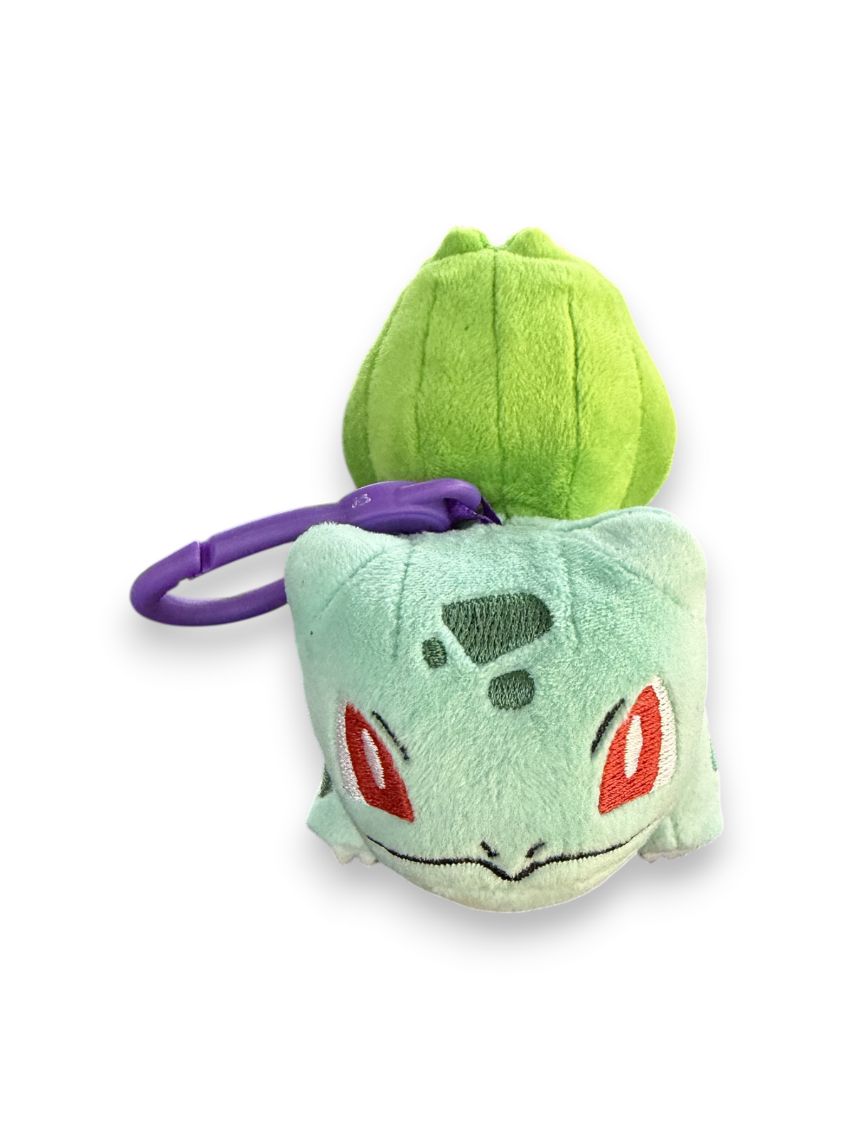 Lowkey Stock Bulbasaur plush keychain with a soft green body, dark green bulb, and a purple plastic clip