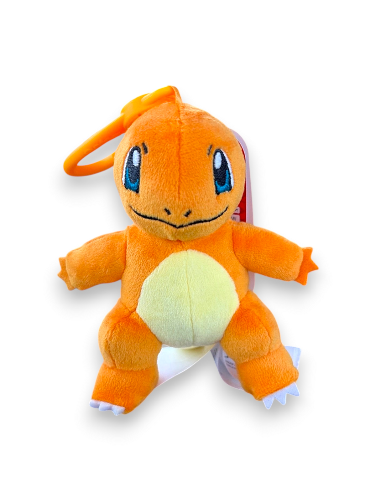 Lowkey Stock Charmander plush keychain featuring soft orange fabric, a yellow belly, and a plastic clip attachment.