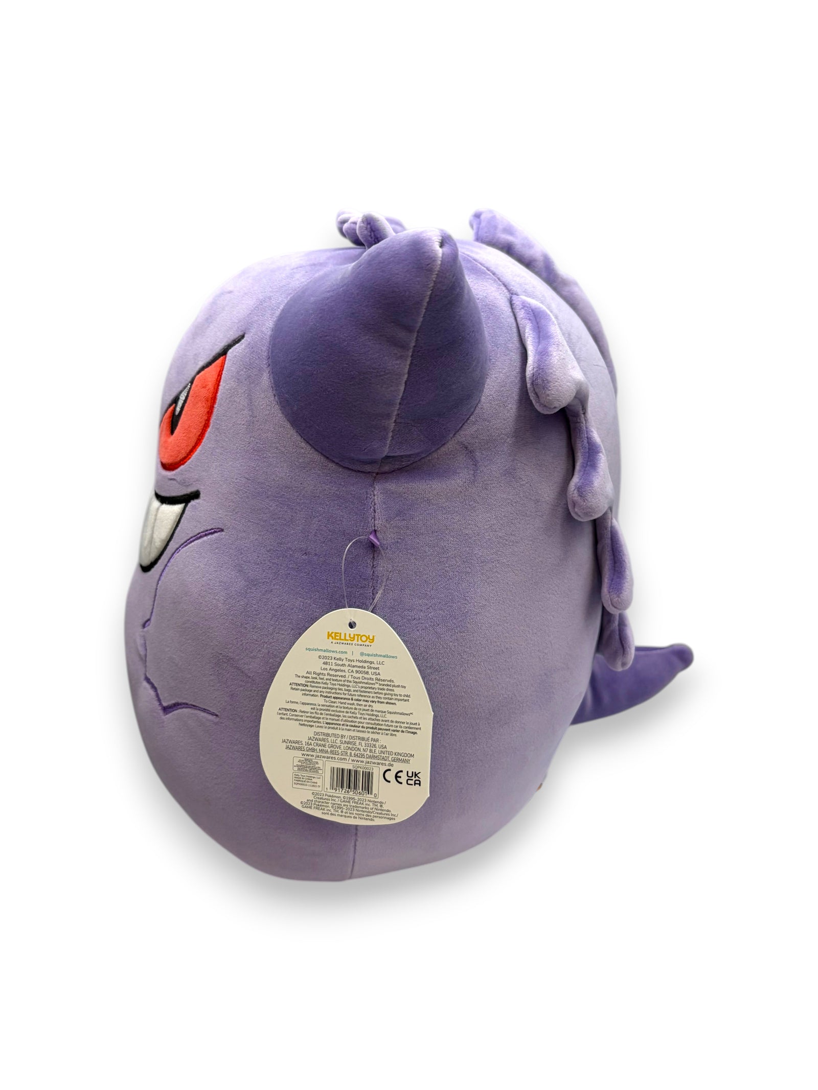 Lowkey Stock 14 inch Gengar plush toy in soft purple fabric with red eyes and white teeth, side view with product tag