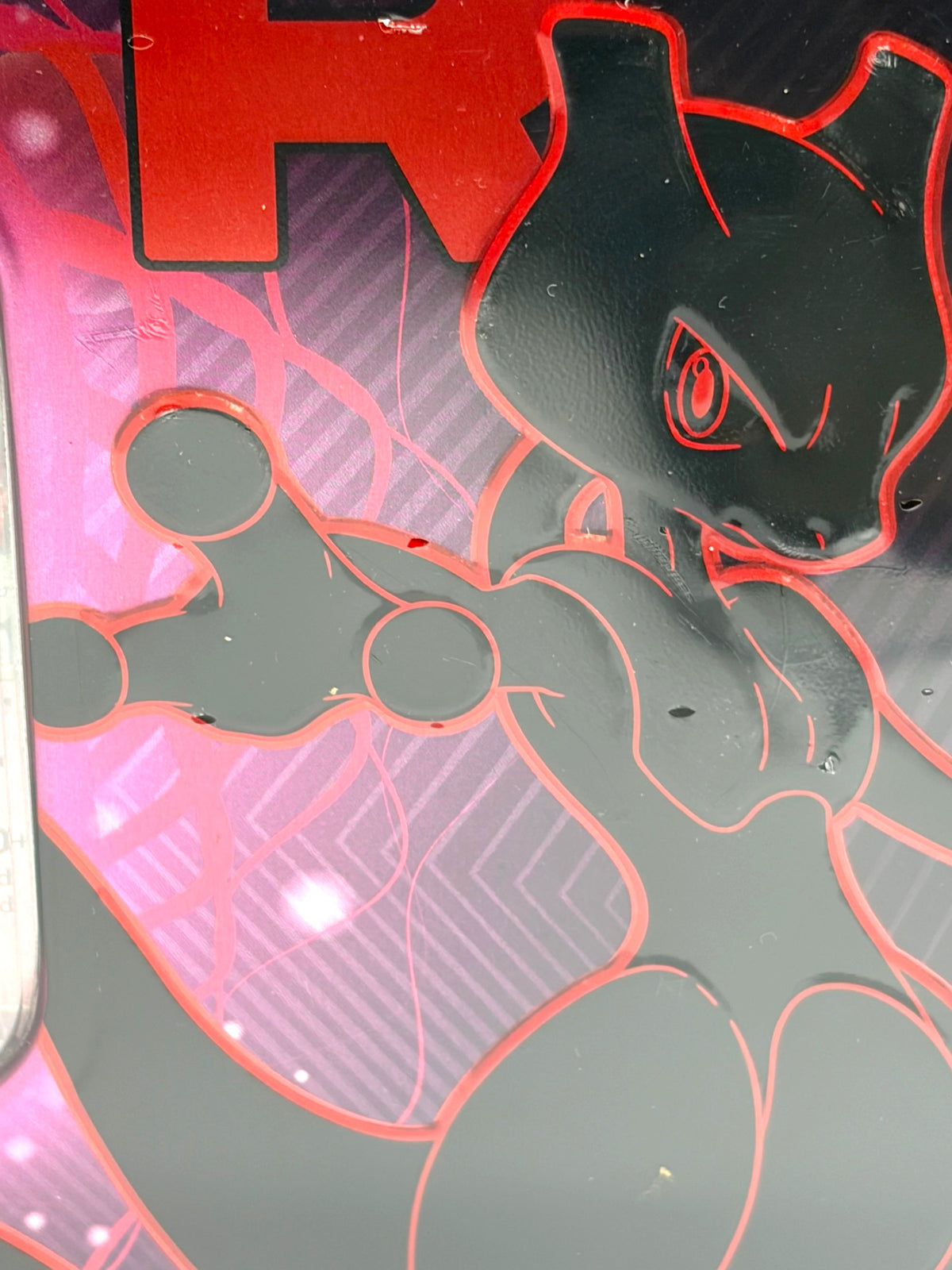 Lowkey Stock Pokemon TCG Team Rockets Mewtwo EX tin featuring a black and red Mewtwo graphic on a sealed metal case