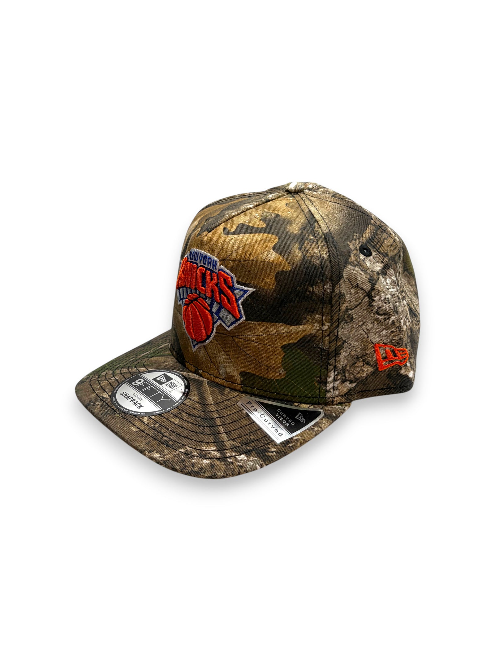 Lowkey Stock New York Knicks 9FIFTY snapback cap featuring a woodland camo print and 2026 Champions side patch.