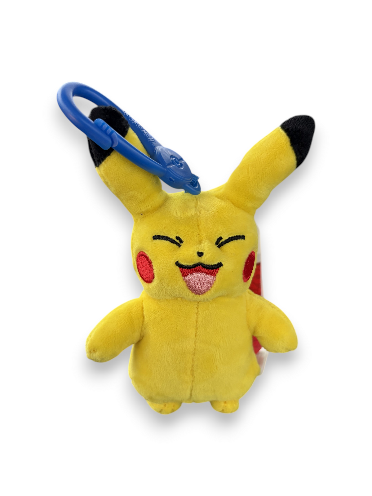 Lowkey Stock Pikachu plush keychain with a happy expression and blue plastic clip on a black surface