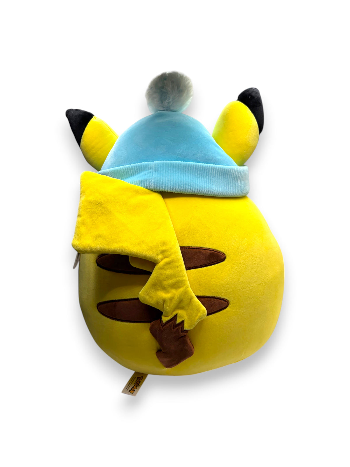 Lowkey Stock 20-inch Pikachu Squishmallow plush wearing a blue winter hat with a pom-pom, back view.