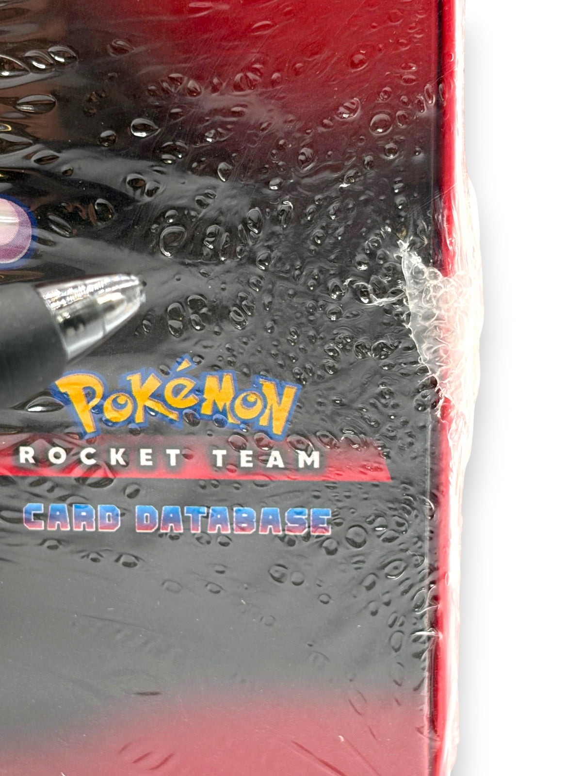 Lowkey Stock sealed Pokemon Team Rocket Card Database box featuring red and black packaging with plastic wrap