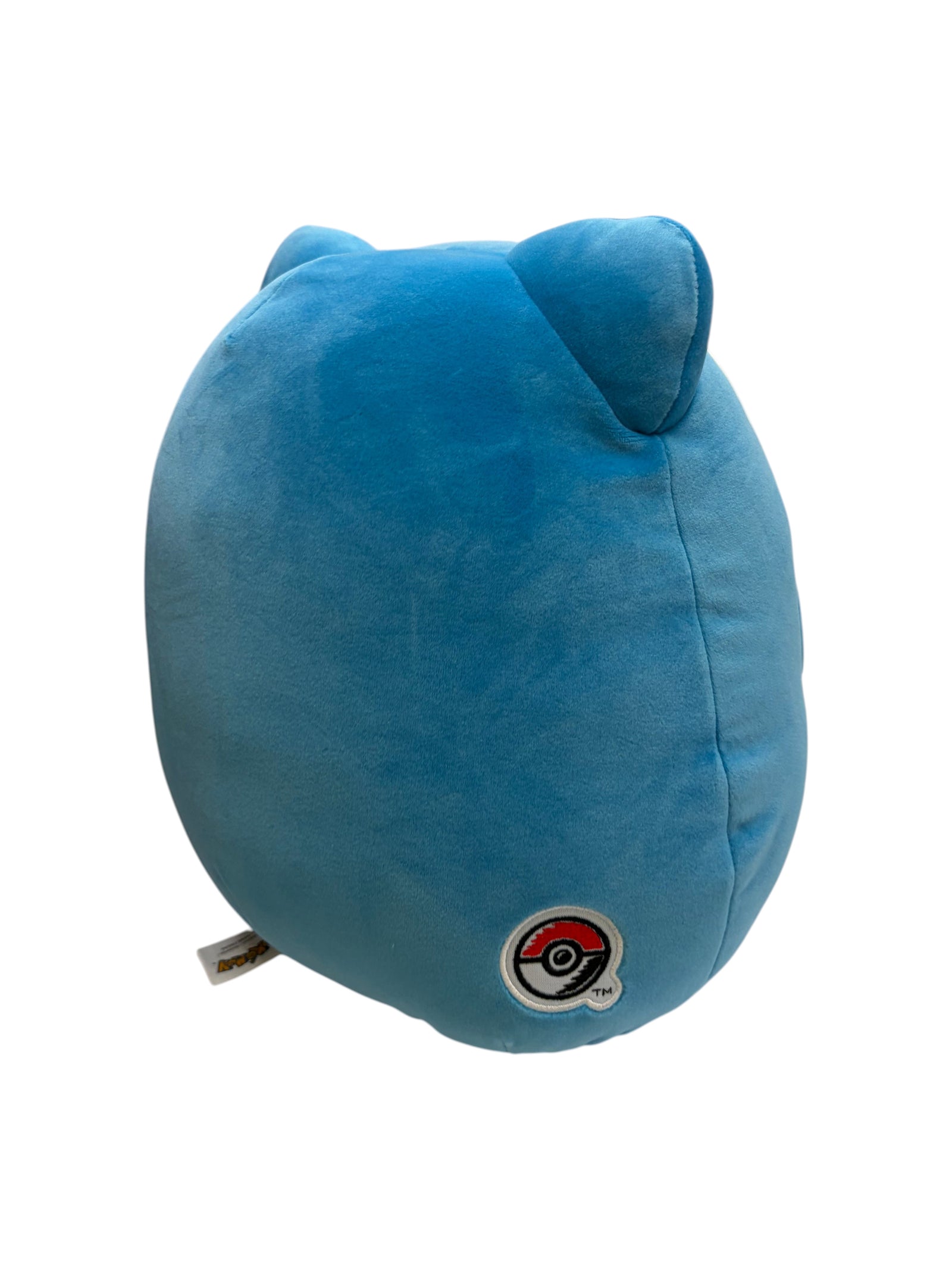 Lowkey Stock blue Snorlax Squishmallows plush toy with a small embroidered Poké Ball detail on the side