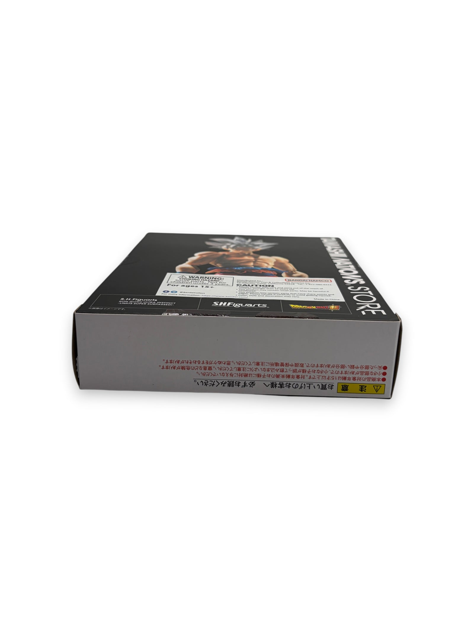 Lowkey Stock S.H.Figuarts Son Goku Ultra Instinct action figure box side view with Japanese warning labels